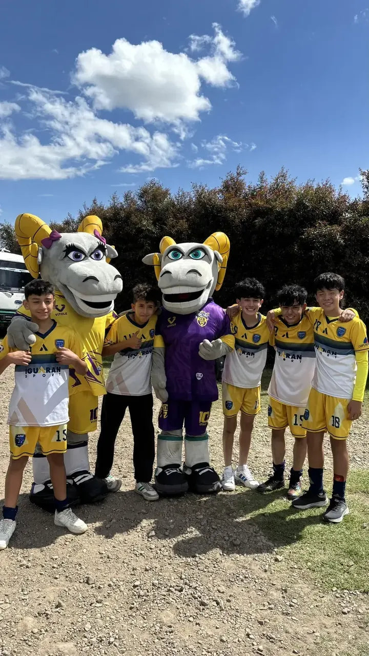 Equipo juvenil posando con las mascotas de la Copa Ciudad Bogotá